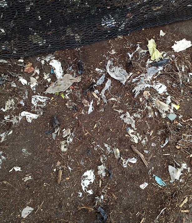 a pile of compost with plastic mixed in