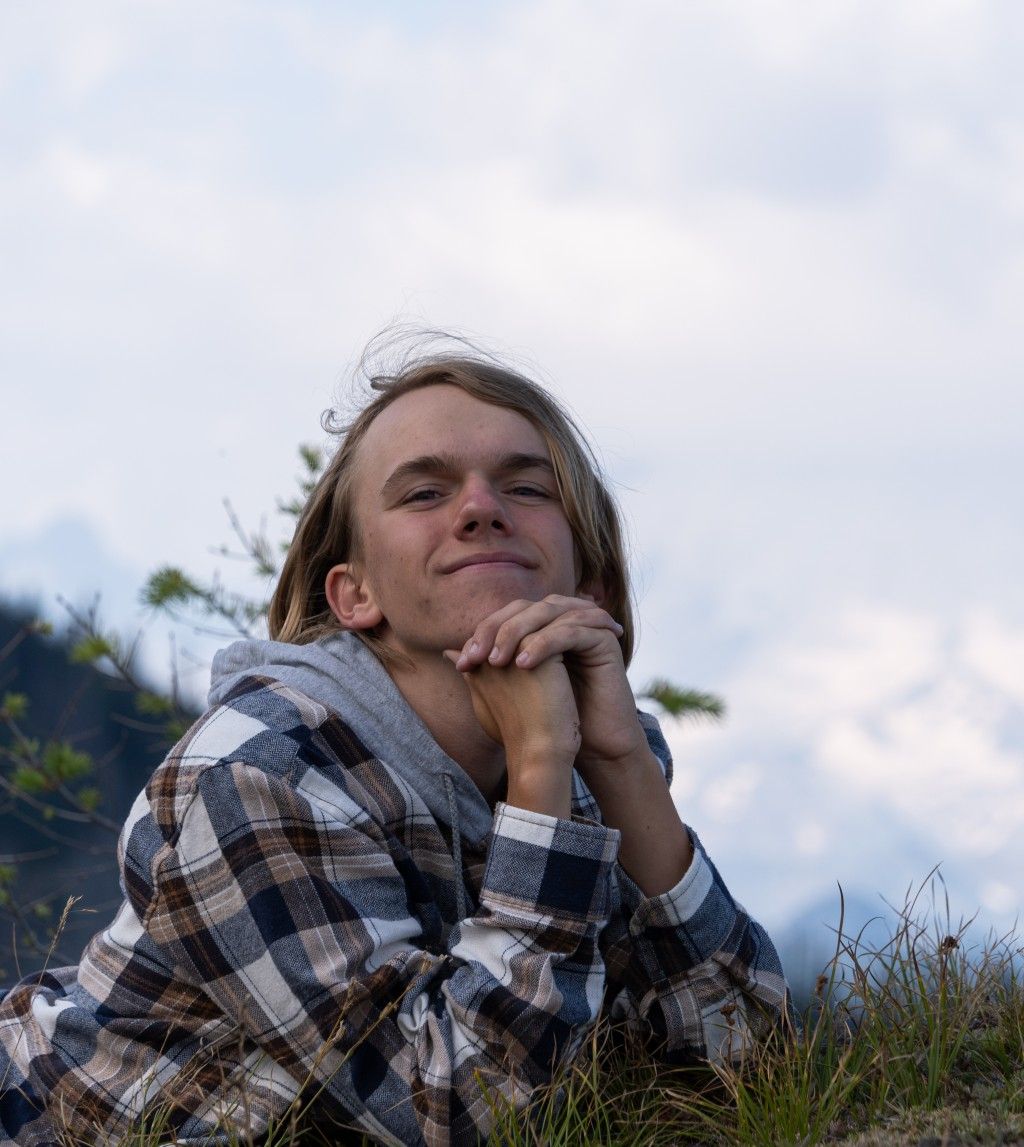 tyler laying down with a mountain in the background